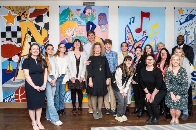 Annapolis High School Art Students and Staff, County Officials, and Light House Staff pose in front of murals displayed in the Light House family room area (Photo Credit: Megan Evans Photography)